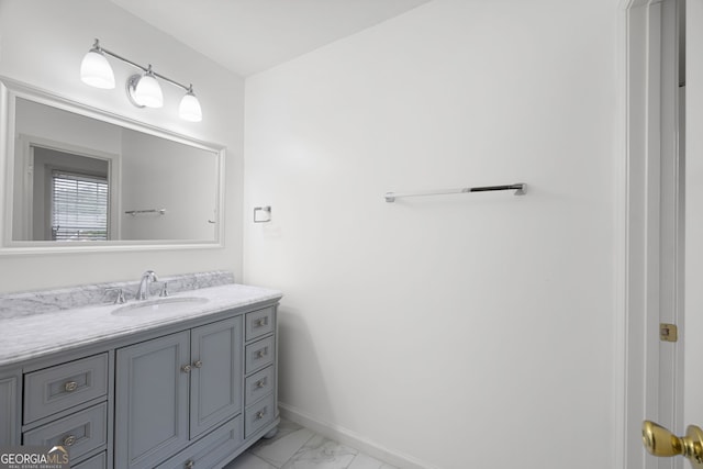 bathroom featuring baseboards, marble finish floor, and vanity