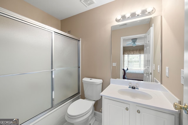 ensuite bathroom with visible vents, vanity, toilet, bath / shower combo with glass door, and connected bathroom