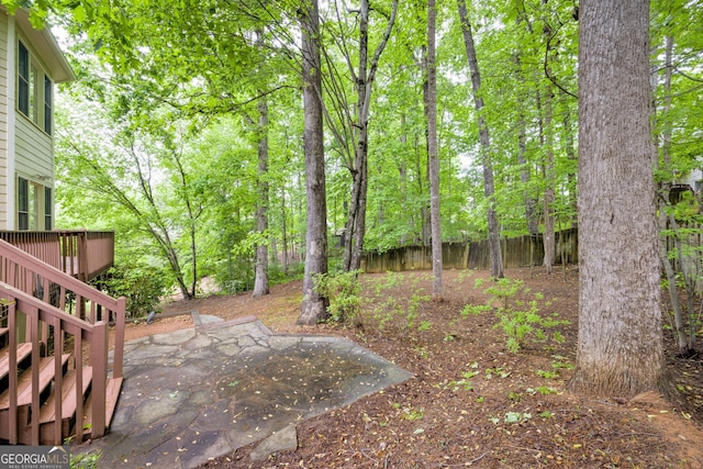 view of yard featuring a patio, stairway, fence, and a deck