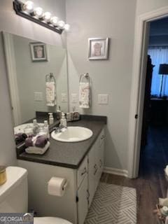bathroom featuring toilet and vanity