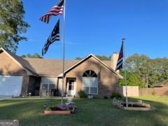 view of front of property featuring a front yard and a garage
