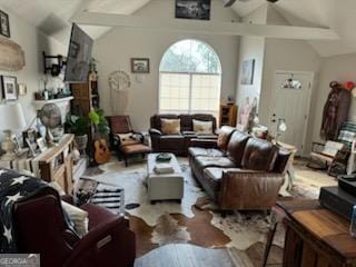 living area featuring ceiling fan and lofted ceiling with beams