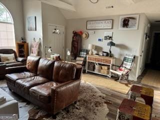 living room featuring lofted ceiling with beams and wood finished floors
