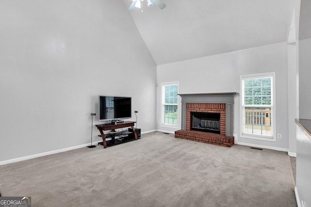 living area with ceiling fan, carpet, a healthy amount of sunlight, and high vaulted ceiling