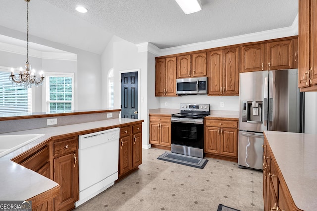 kitchen featuring vaulted ceiling, stainless steel appliances, brown cabinets, and hanging light fixtures