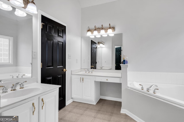 full bathroom with baseboards, tile patterned floors, a garden tub, and vanity