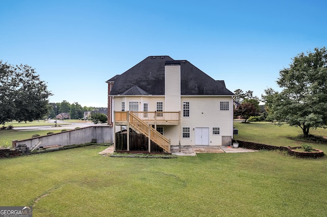 rear view of property featuring stairway, a wooden deck, and a yard