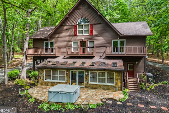 339 Ben Loudermilk Rd, Mount Airy, GA 30563 - back of house featuring a hot tub, roof with shingles, french doors, stone siding, and a balcony