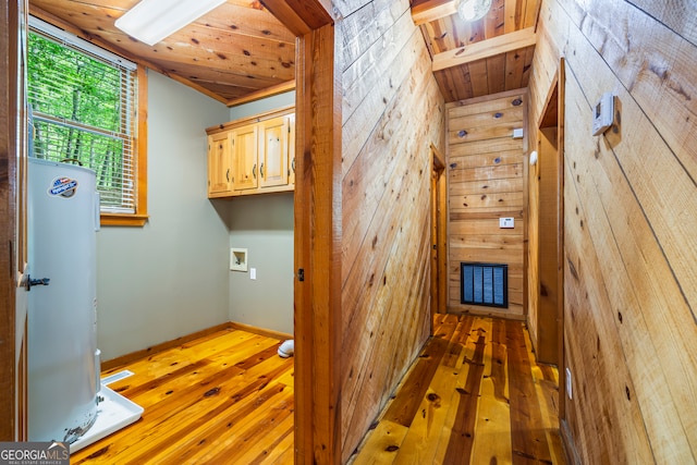 339 Ben Loudermilk Rd, Mount Airy, GA 30563 - interior space featuring water heater, wooden walls, wood-type flooring, and cabinet space