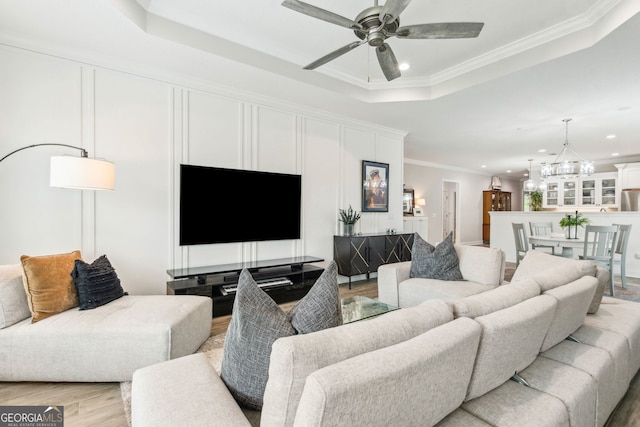 107 Amanda Trce, Kingsland, GA 31548 - living area with a tray ceiling, recessed lighting, ceiling fan, light wood-style flooring, and crown molding