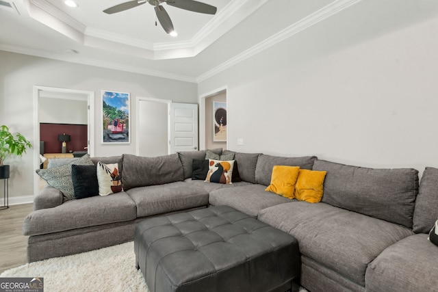 107 Amanda Trce, Kingsland, GA 31548 - living area with a tray ceiling, wood finished floors, ornamental molding, ceiling fan, and baseboards