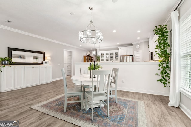 107 Amanda Trce, Kingsland, GA 31548 - dining space with a chandelier, light wood-style floors, baseboards, recessed lighting, and crown molding