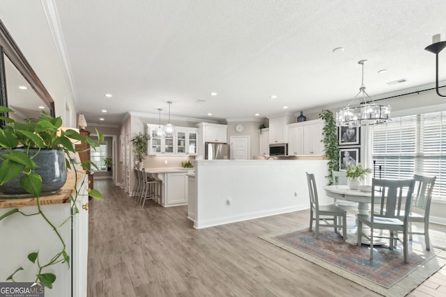 107 Amanda Trce, Kingsland, GA 31548 - dining space with a chandelier, ornamental molding, light wood-style flooring, and recessed lighting