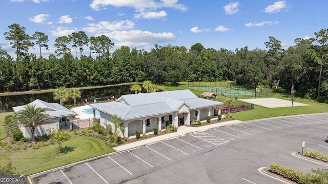 107 Amanda Trce, Kingsland, GA 31548 - view of building exterior with uncovered parking, fence, and view of scattered trees