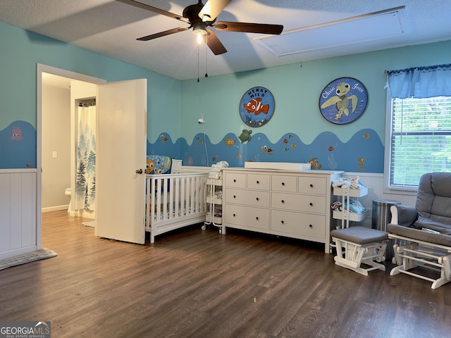 1685 Ridgeway Rd, Lafayette, GA 30728 - bedroom featuring attic access, wainscoting, wood finished floors, a crib, and a ceiling fan