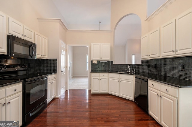 5975 Tate Dr, Austell, GA 30106 - kitchen featuring a sink, dark countertops, backsplash, and black appliances