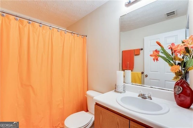 10202 Fairington Ridge Cir, Lithonia, GA 30038 - full bath with visible vents, vanity, toilet, a textured ceiling, and a shower with curtain