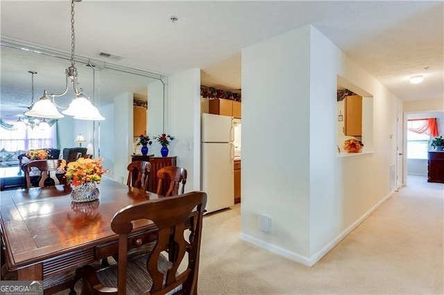 10202 Fairington Ridge Cir, Lithonia, GA 30038 - dining space featuring light colored carpet, baseboards, and a chandelier
