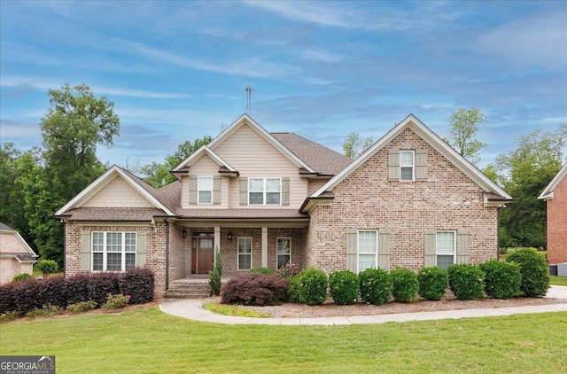 135 Broadleaf Dr, Macon, GA 31210 - craftsman-style home featuring roof with shingles, covered porch, a front lawn, and brick siding