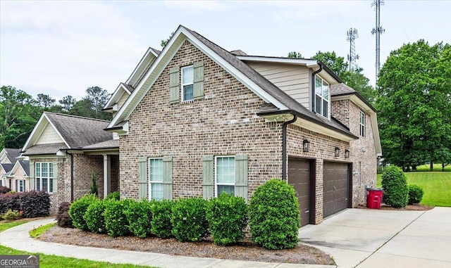 135 Broadleaf Dr, Macon, GA 31210 - view of home's exterior featuring brick siding, driveway, a shingled roof, and a garage