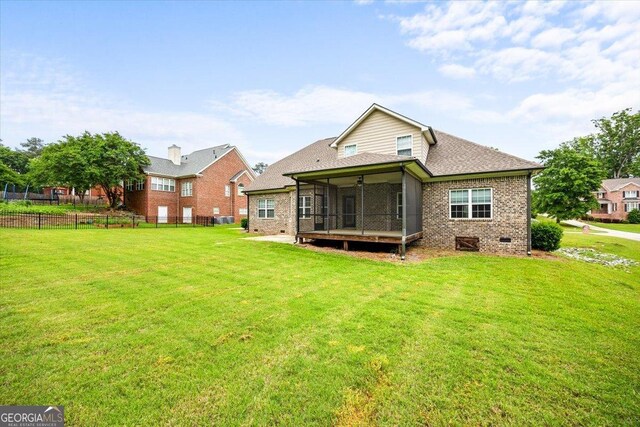 135 Broadleaf Dr, Macon, GA 31210 - rear view of house featuring a lawn, brick siding, fence, and a sunroom