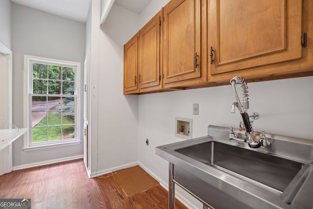 laundry room featuring hookup for a washing machine, cabinet space, dark wood-style flooring, baseboards, and healthy amount of natural light