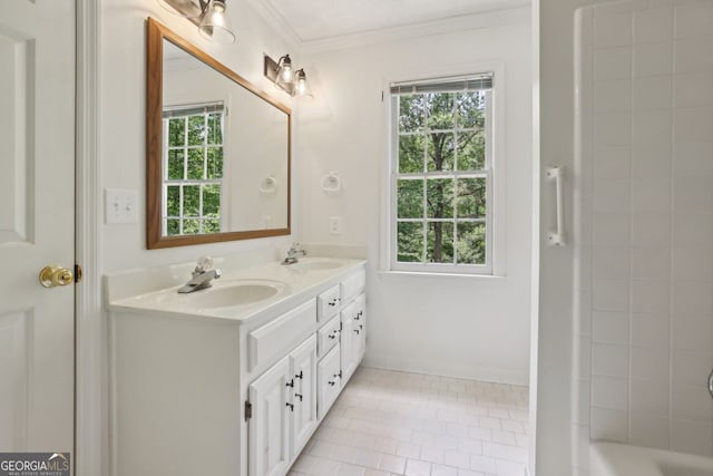 bathroom with ornamental molding, tile patterned flooring, double vanity, and baseboards
