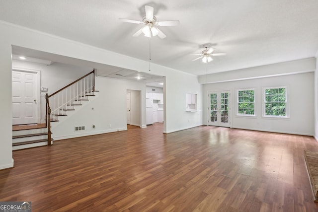 unfurnished living room with stairway, a ceiling fan, wood finished floors, and baseboards