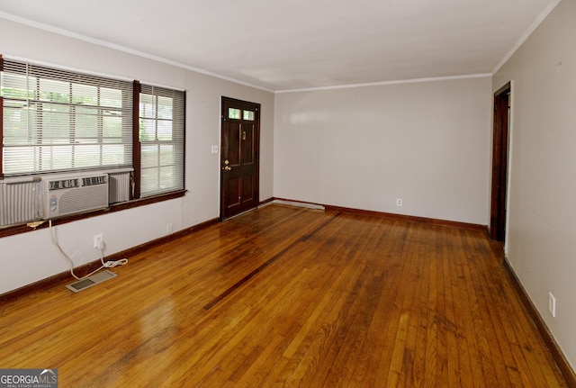 foyer with crown molding, cooling unit, hardwood / wood-style floors, and visible vents