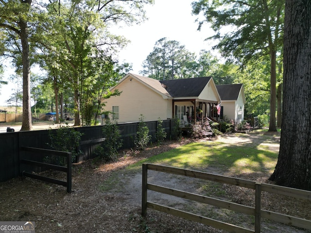 exterior space featuring a lawn and fence private yard