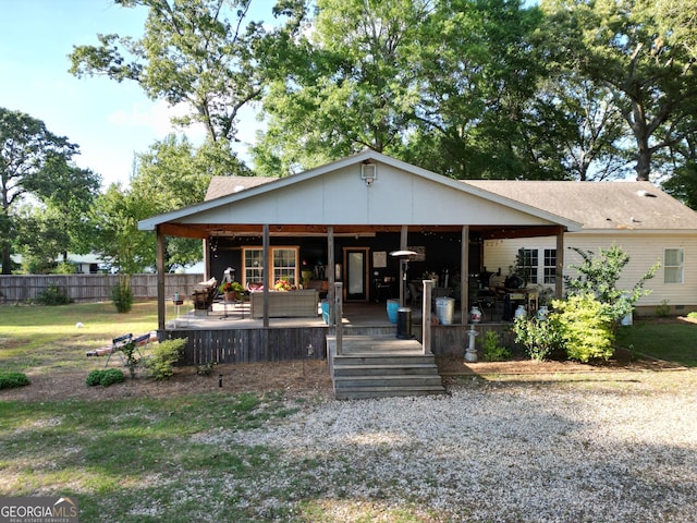 bungalow-style home featuring fence and outdoor lounge area