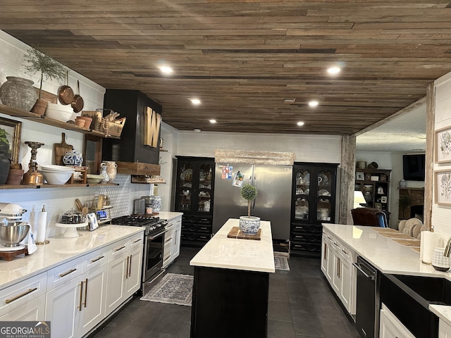 kitchen featuring light countertops, appliances with stainless steel finishes, white cabinets, and wooden ceiling