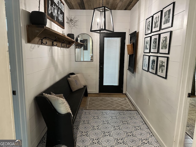 doorway with wood ceiling and tile patterned floors