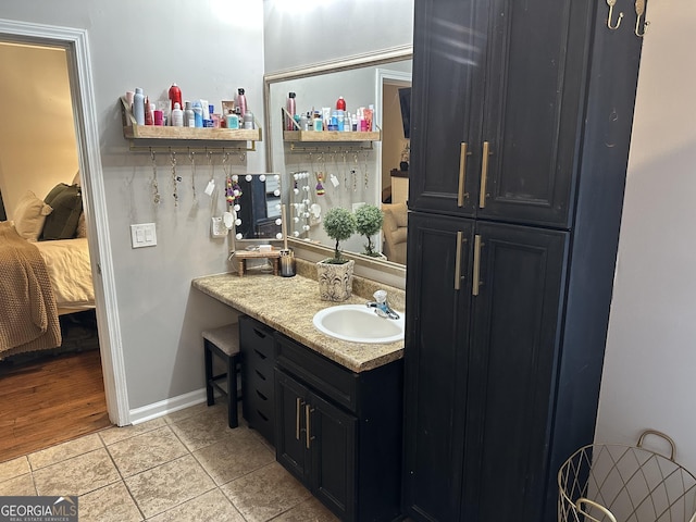bathroom with vanity and ensuite bath