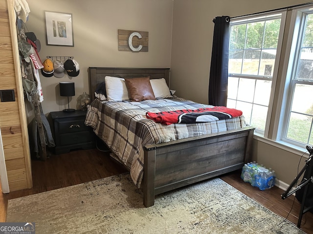 bedroom with baseboards and wood finished floors