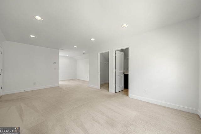 interior space featuring recessed lighting, baseboards, and light carpet