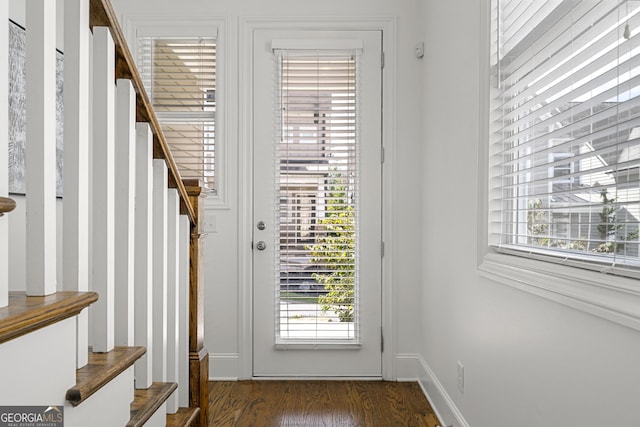 doorway to outside featuring baseboards, plenty of natural light, stairs, and wood finished floors