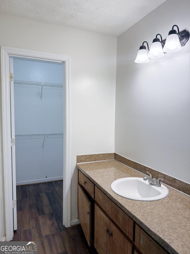 5349 Minnie Lee Dr, Columbus, GA 31907 - bathroom featuring vanity, wood finished floors, and a walk in closet