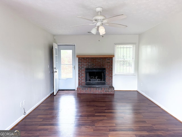 5349 Minnie Lee Dr, Columbus, GA 31907 - unfurnished living room featuring healthy amount of natural light, wood finished floors, a ceiling fan, and a brick fireplace
