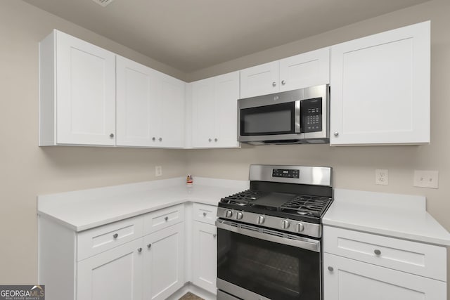 kitchen featuring white cabinets, light countertops, and stainless steel appliances