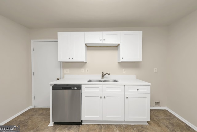 kitchen featuring white cabinets, light countertops, stainless steel dishwasher, and a sink