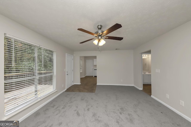 empty room featuring baseboards, ceiling fan, and carpet floors