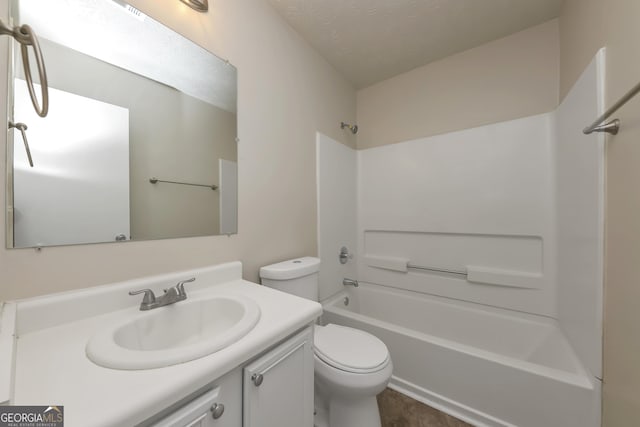 bathroom with bathtub / shower combination, toilet, vanity, and a textured ceiling