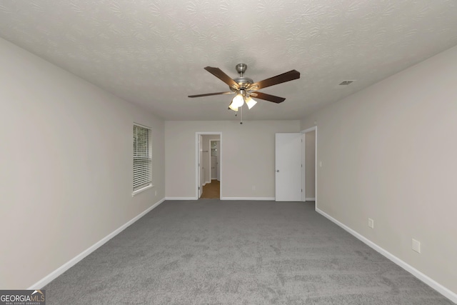 unfurnished room with a ceiling fan, baseboards, and visible vents