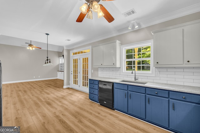 kitchen with visible vents, ceiling fan, black dishwasher, blue cabinets, and a sink
