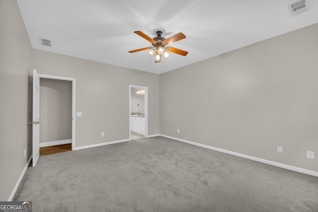 unfurnished bedroom featuring baseboards, carpet flooring, and visible vents