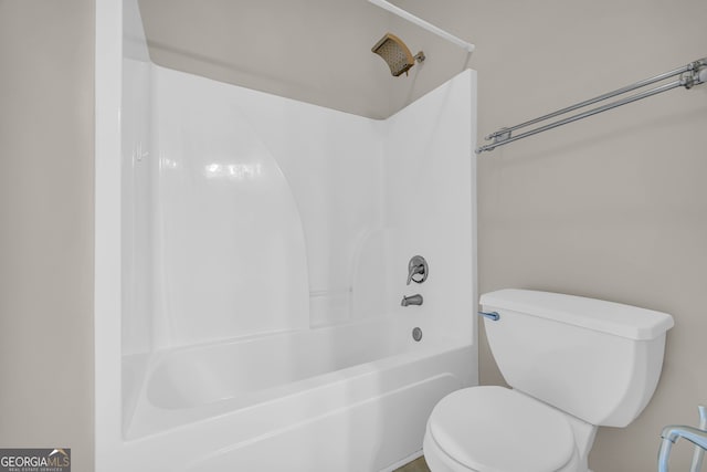 bathroom featuring toilet and shower / washtub combination