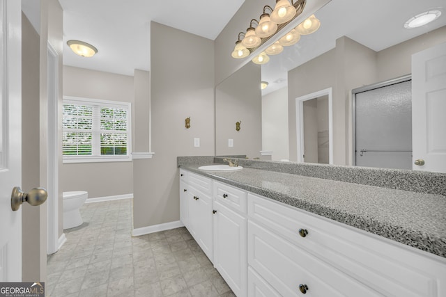 full bath with baseboards, vanity, and toilet