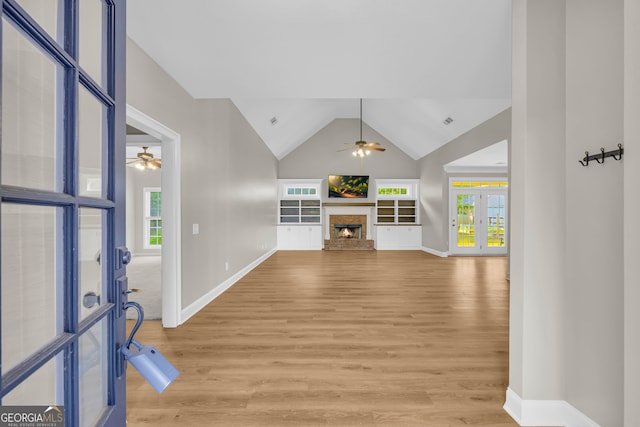 entryway with ceiling fan, french doors, and light wood-type flooring