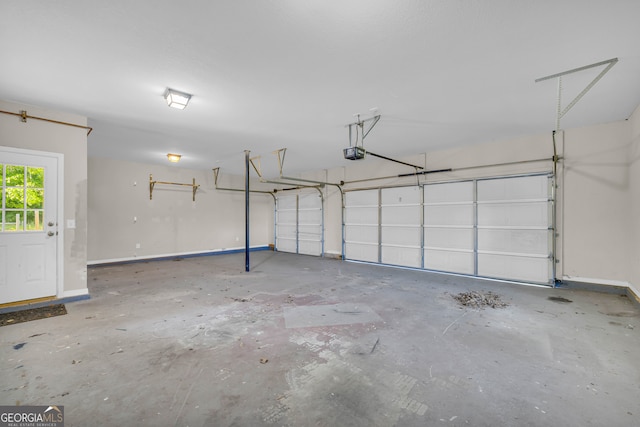 garage with baseboards and a garage door opener